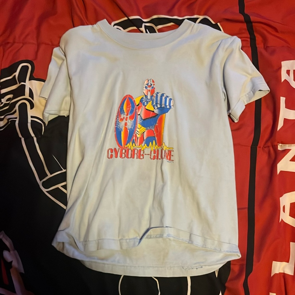 A light blue shirt with a cyborg on it